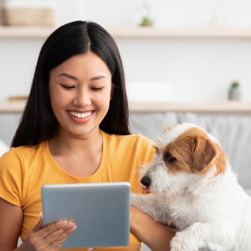 a woman sitting on the floor with a dog